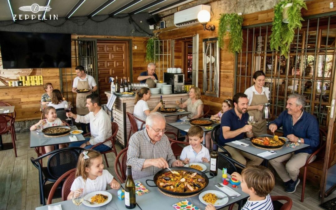 Familia disfrutando de una comida en la terraza de Restaurante Zeppelin en primavera
